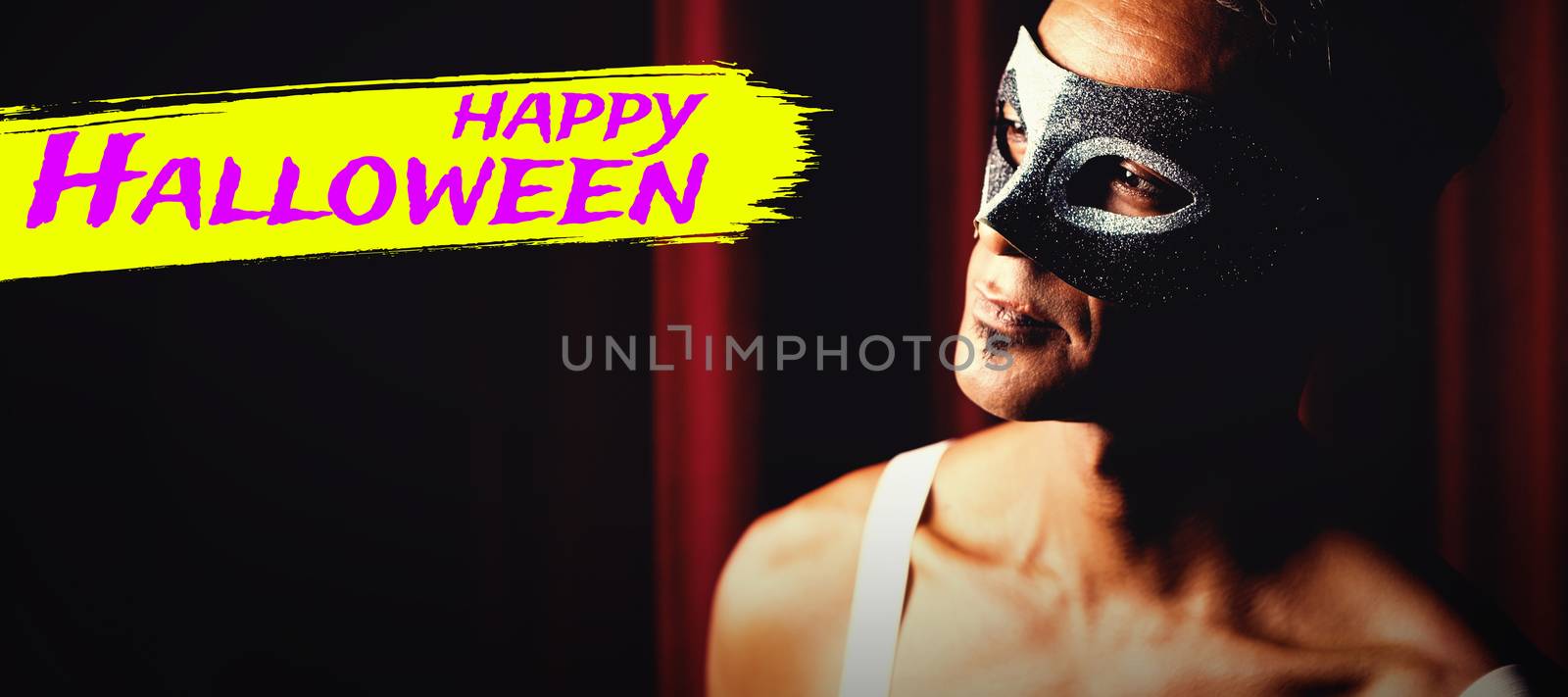 Digital image of happy Halloween text against man in masquerade mask