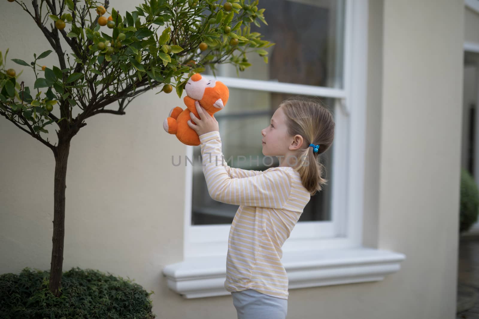 Young girl holding soft toy by Wavebreakmedia