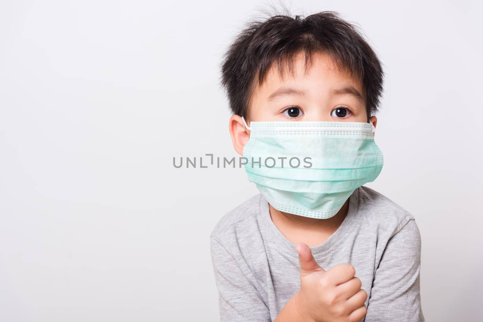 Closeup Asian face, Little children boy sick he using medicine healthcare mask on white background with copy space, health medical care