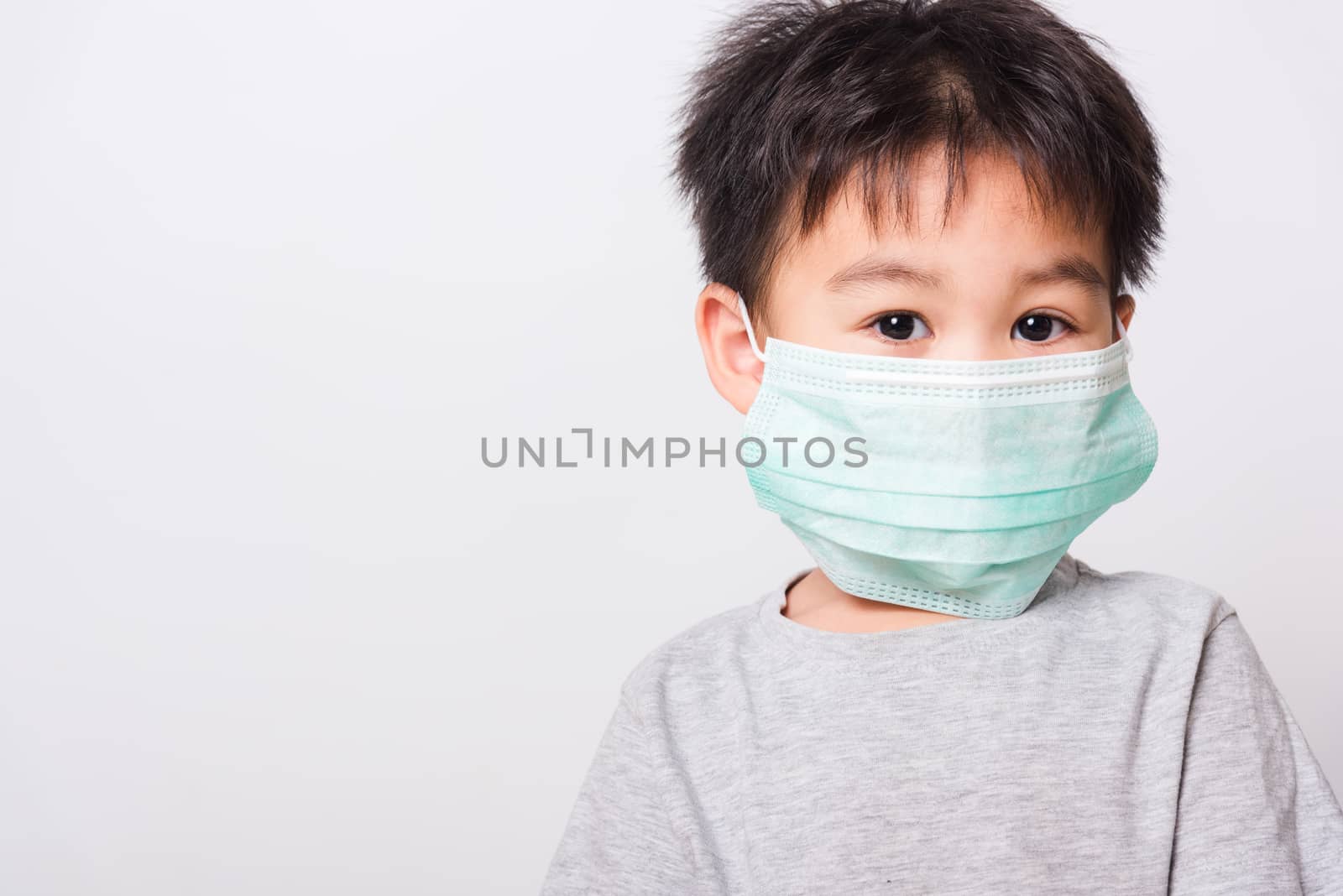Closeup Asian face, Little children boy sick he using medicine healthcare mask on white background with copy space, health medical care