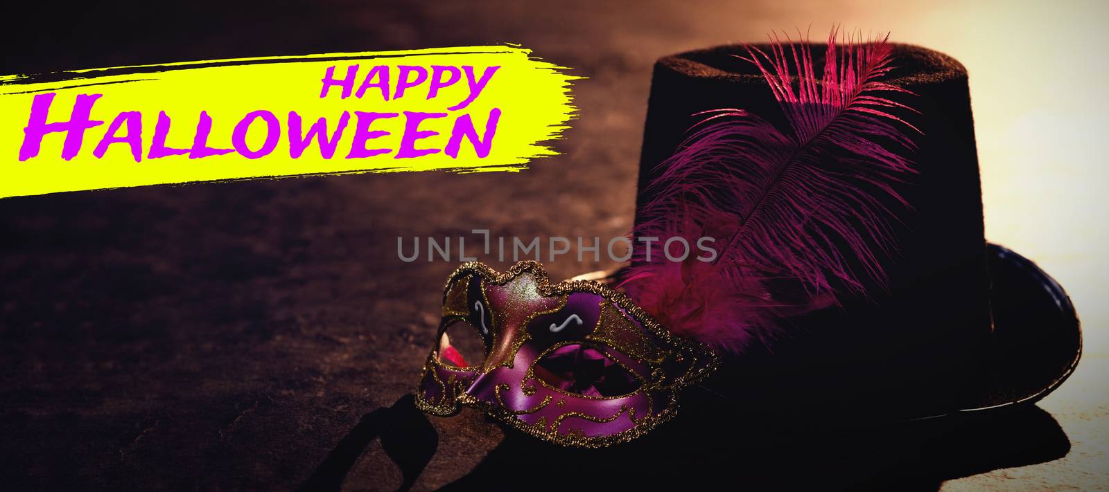 Digital image of happy Halloween text against masquerade masks and hat