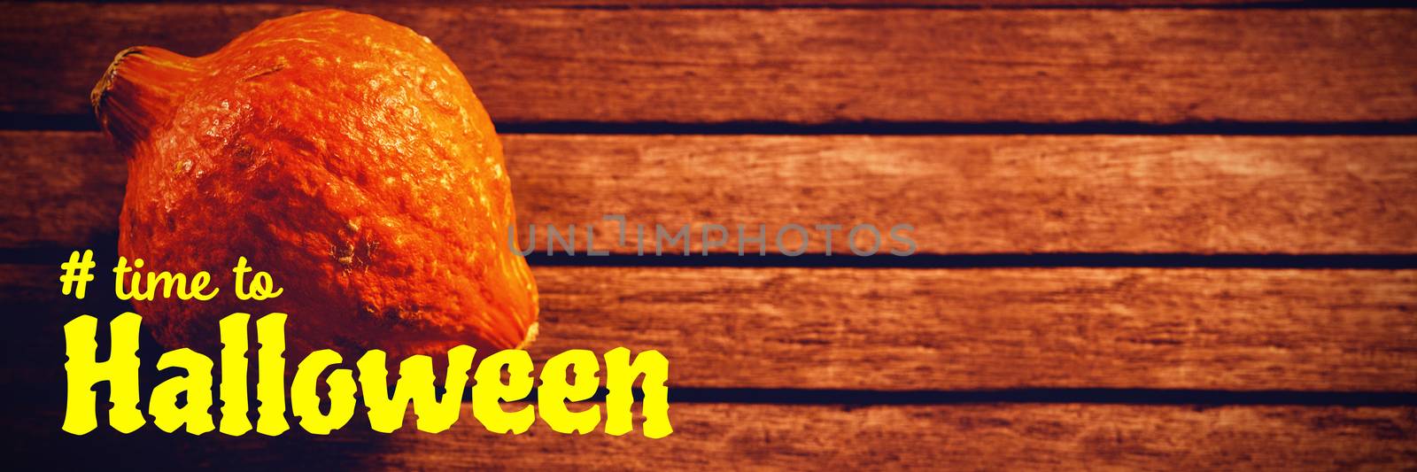 Digital image of time to Halloween text against squash on wooden table during halloween