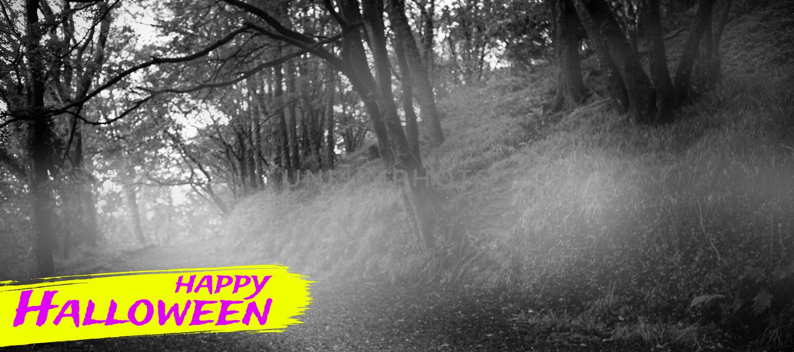Digital image of happy Halloween text against way between trees