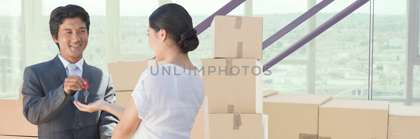 people moving boxes into new home with key by Wavebreakmedia