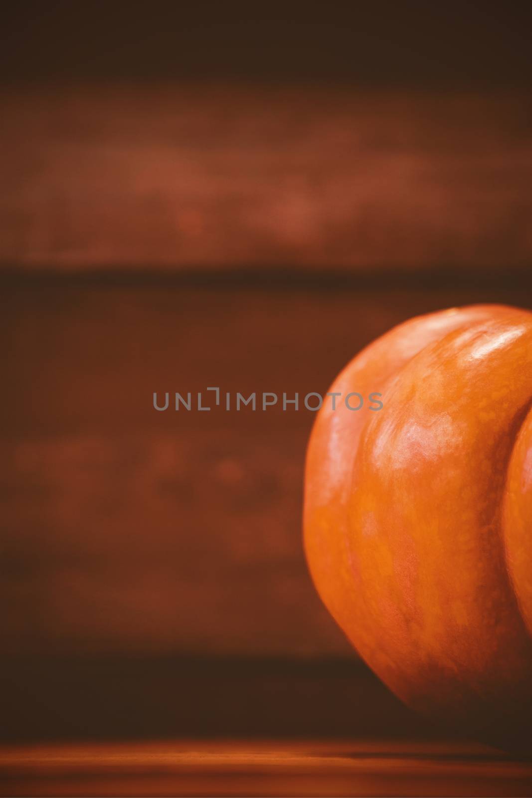 Cropped image of pumpkin on table during Halloween by Wavebreakmedia