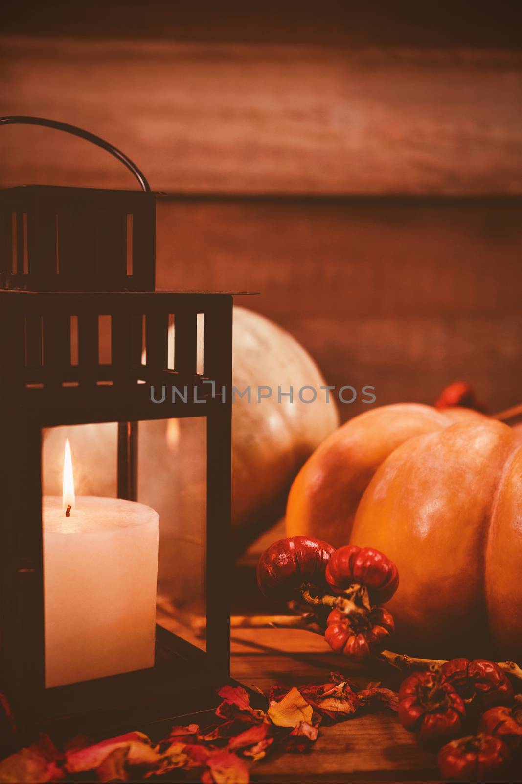 Pumpkins and burning candles on table during Halloween