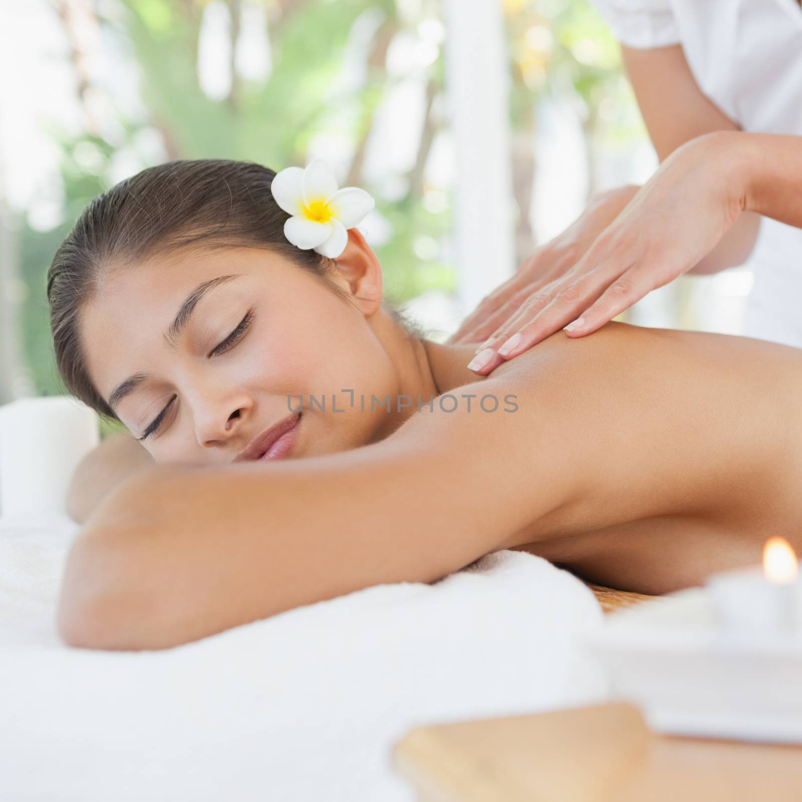 Beautiful brunette enjoying a massage at the health spa