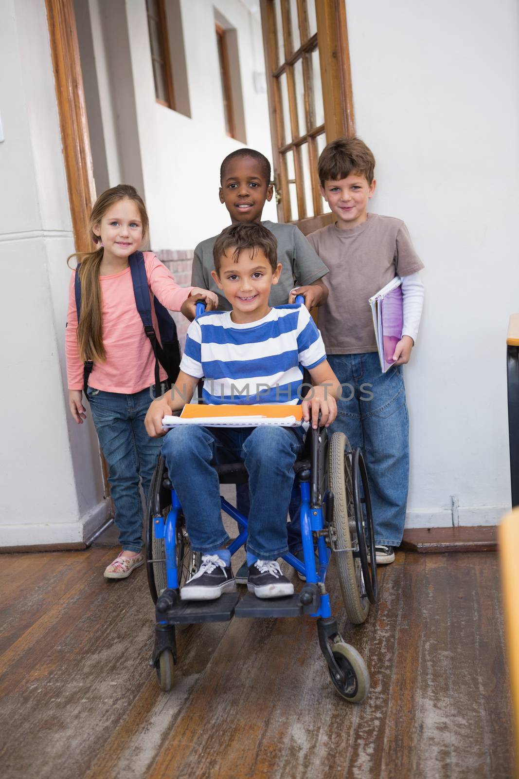 Disabled pupil with his friends in classroom by Wavebreakmedia