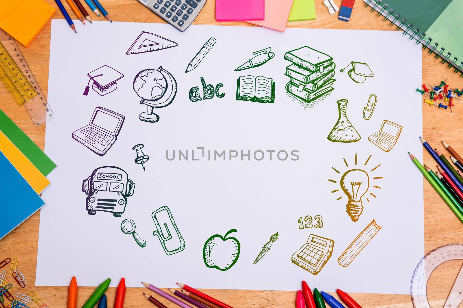 Composite image of education doodles against students desk