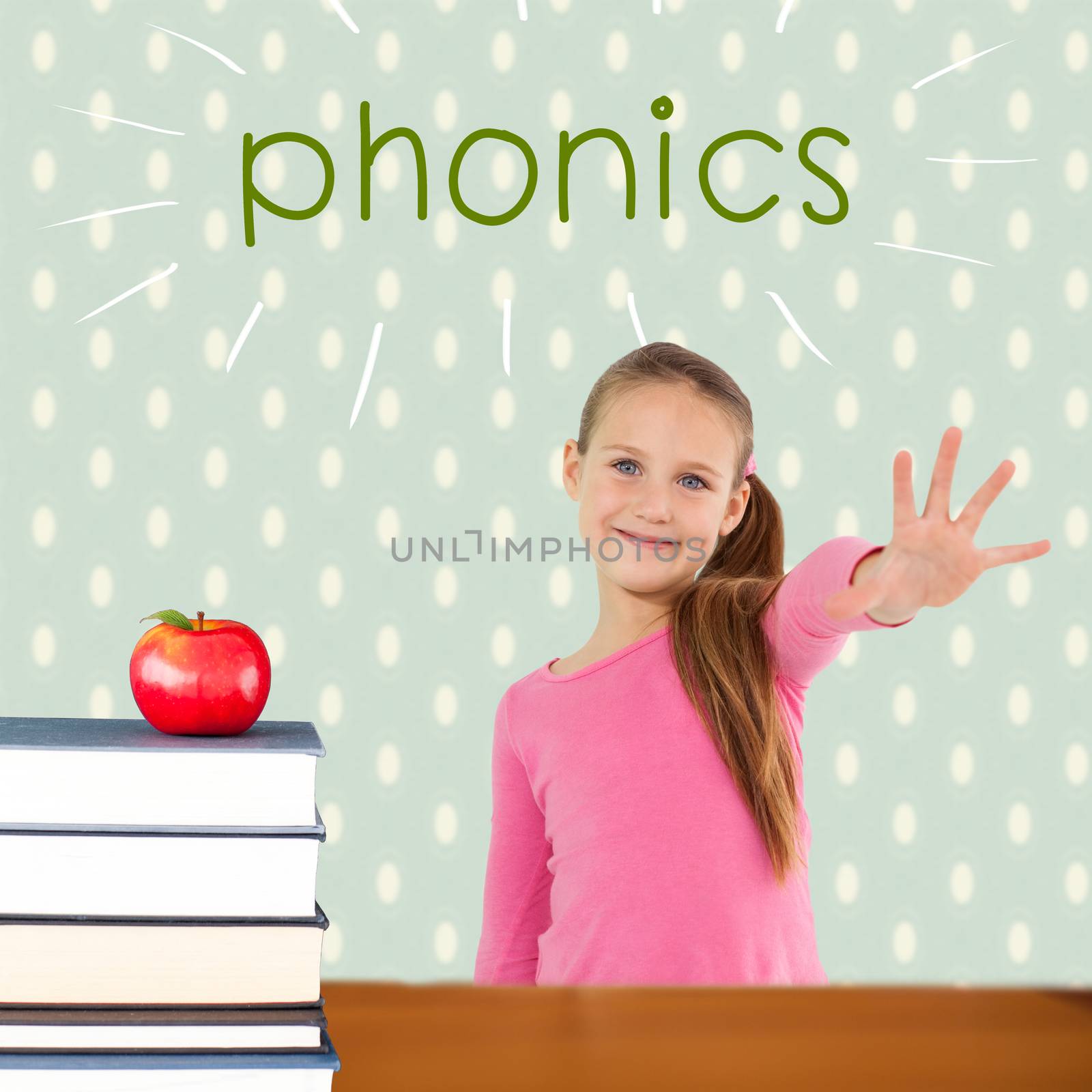 The word phonics and cute girl with hand out against red apple on pile of books