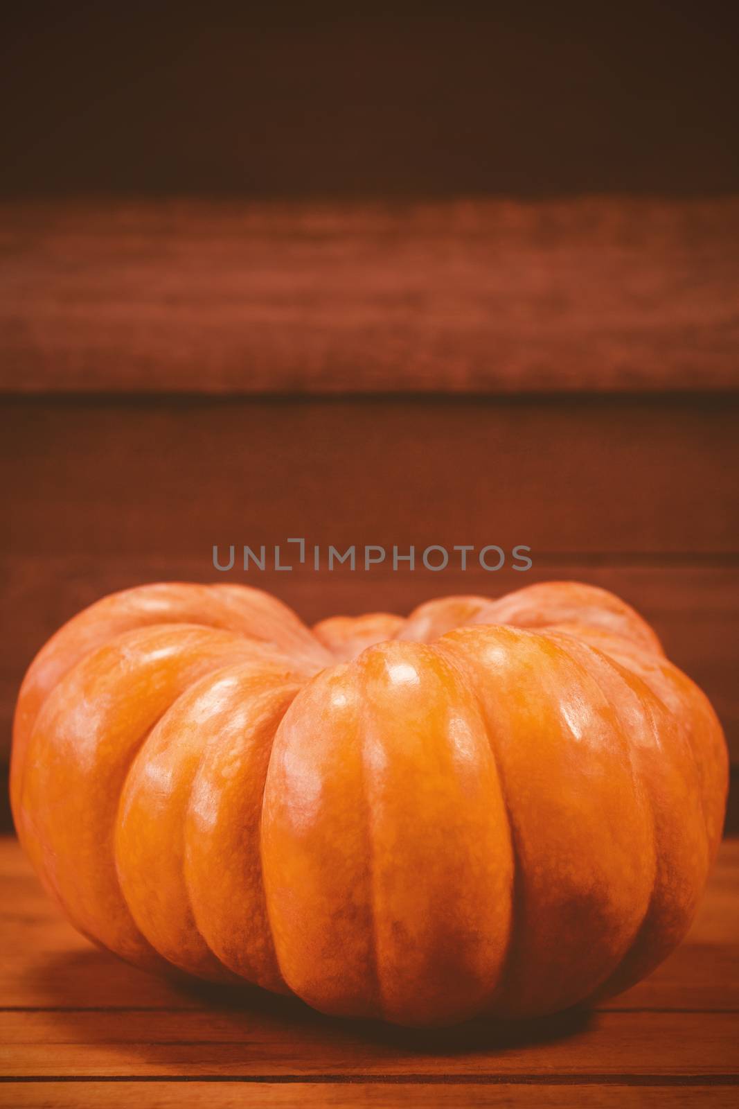 Pumpkin on wooden table during Halloween by Wavebreakmedia