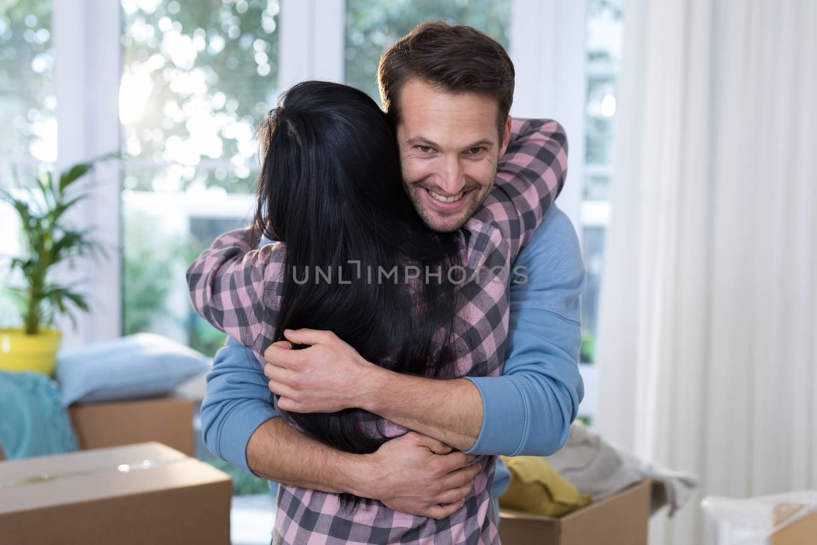 Romantic couple embracing each other at new home
