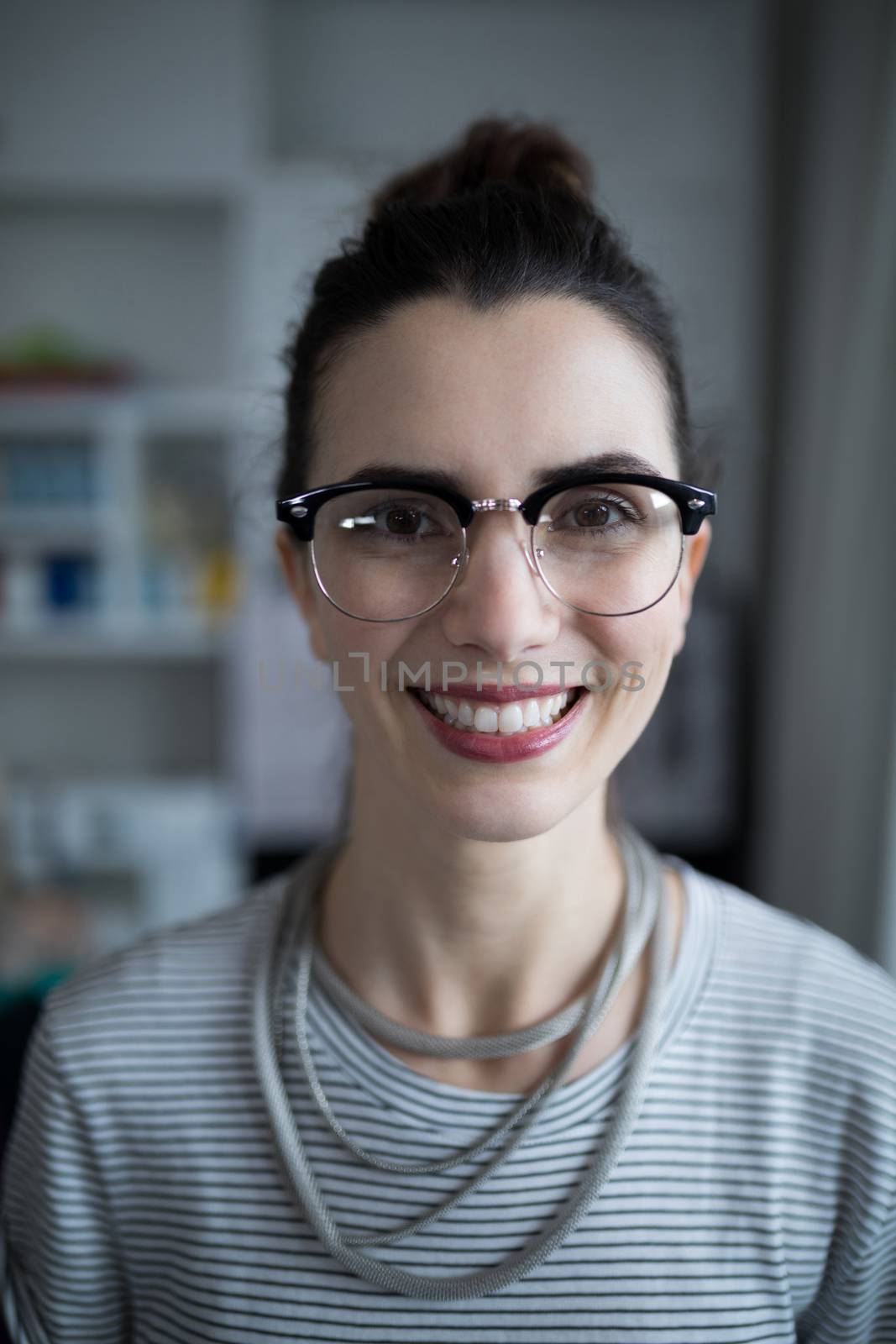 Portrait of smiling fashion designer at home