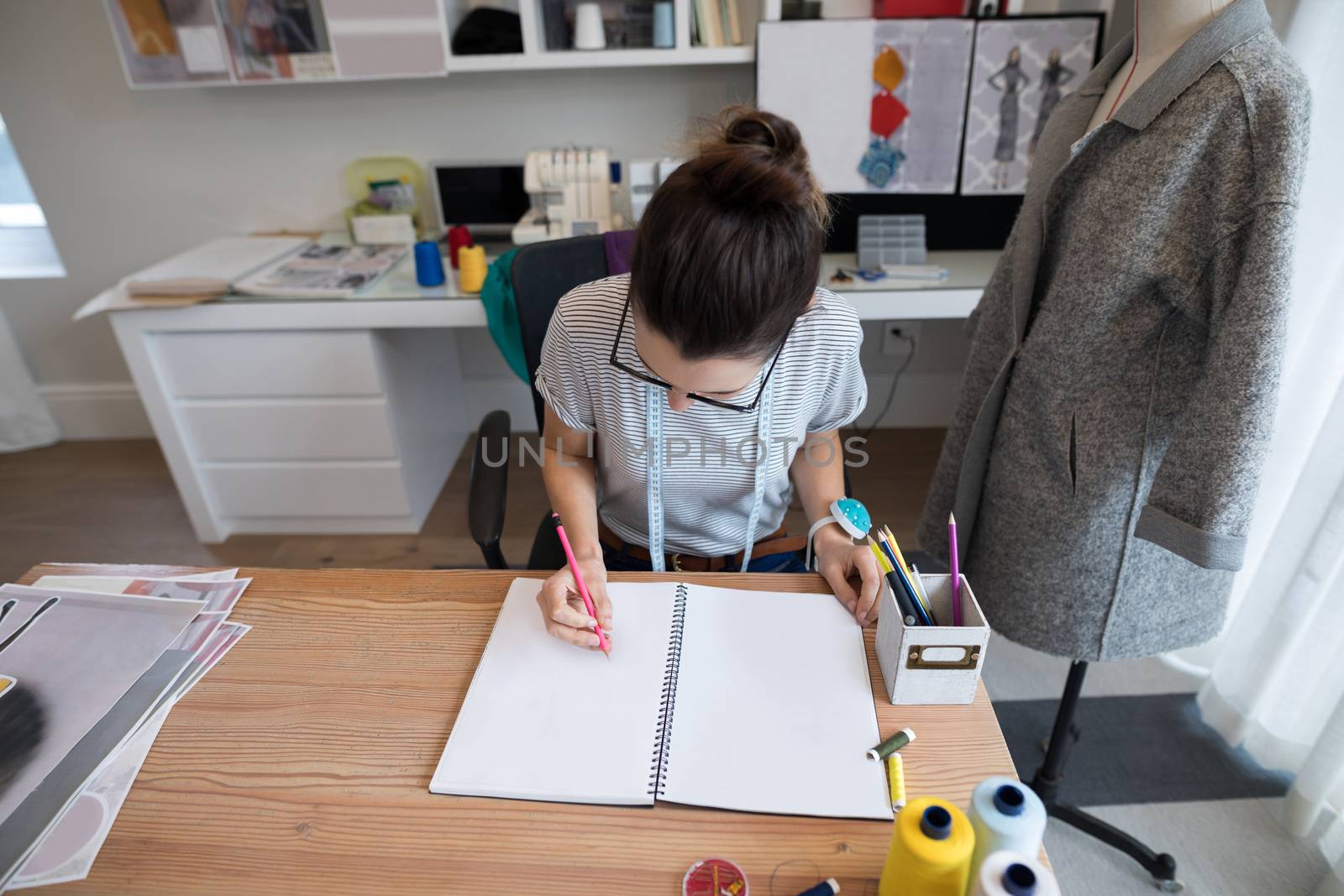 Young fashion designer working at desk