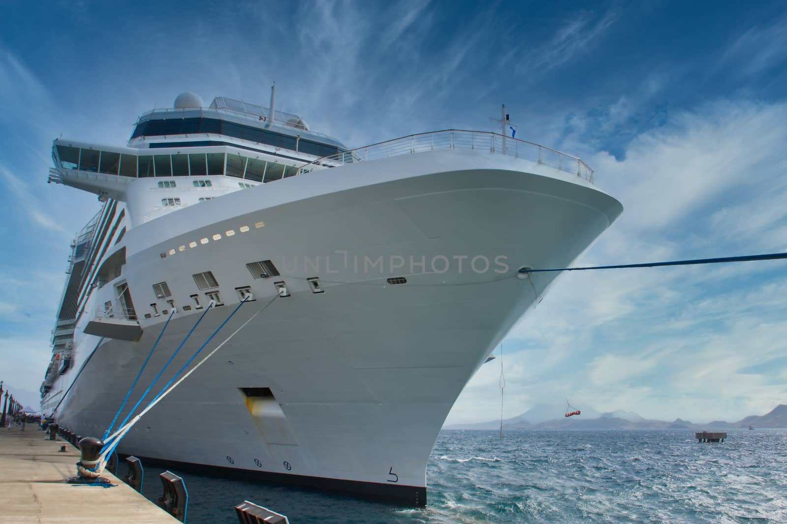 Huge White Cruise Ship Tied to Bollard on Pier by dbvirago