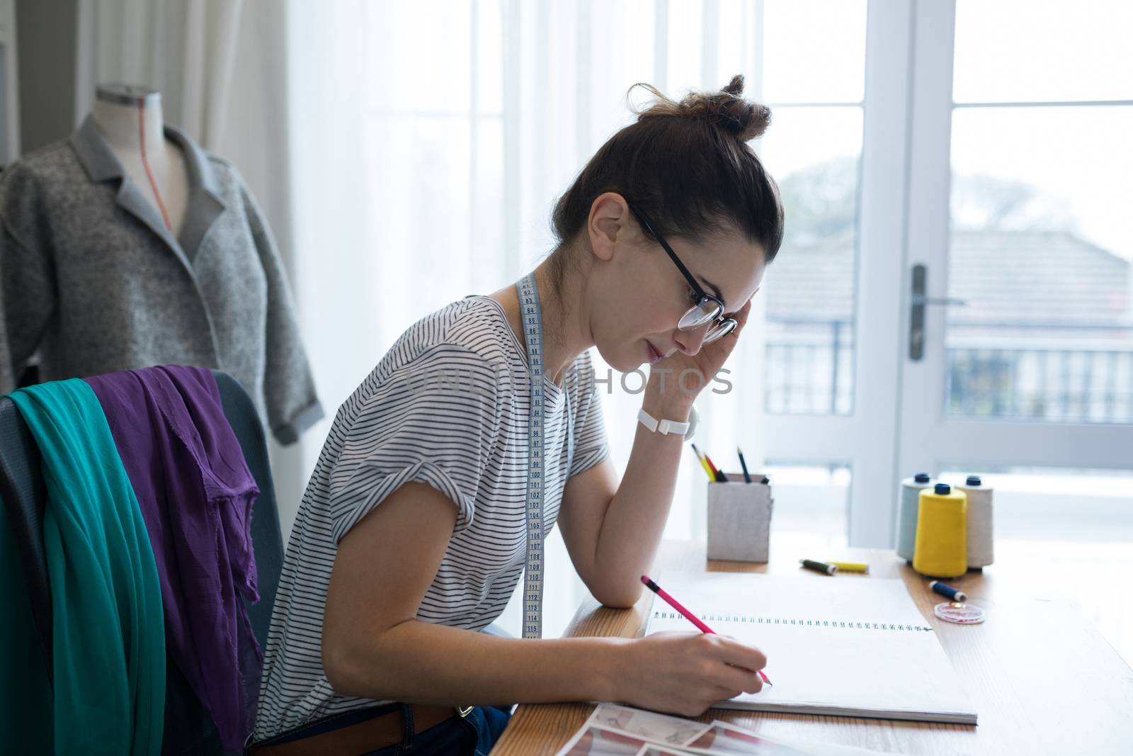 Young fashion designer working at desk