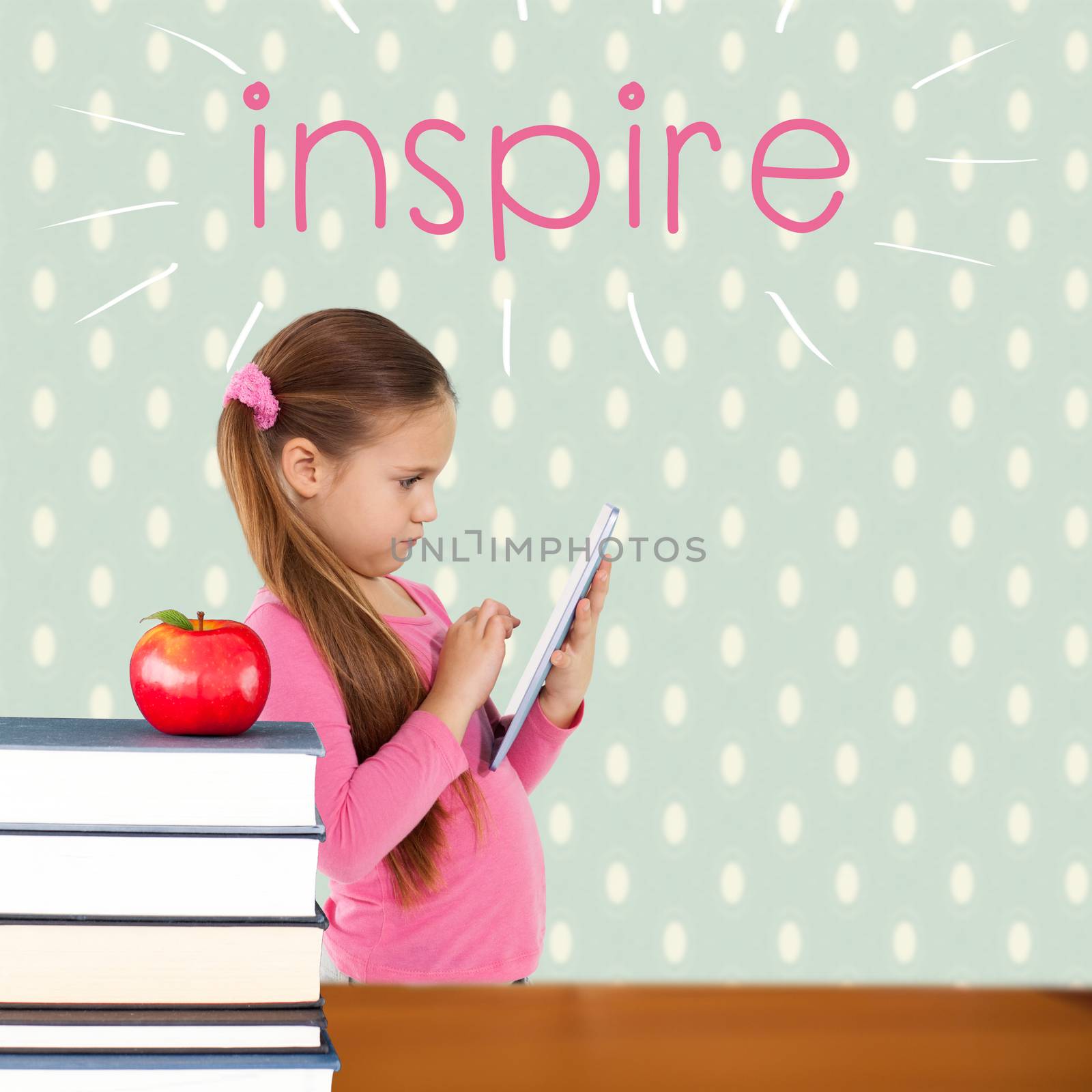 The word inspire and cute girl using tablet against red apple on pile of books