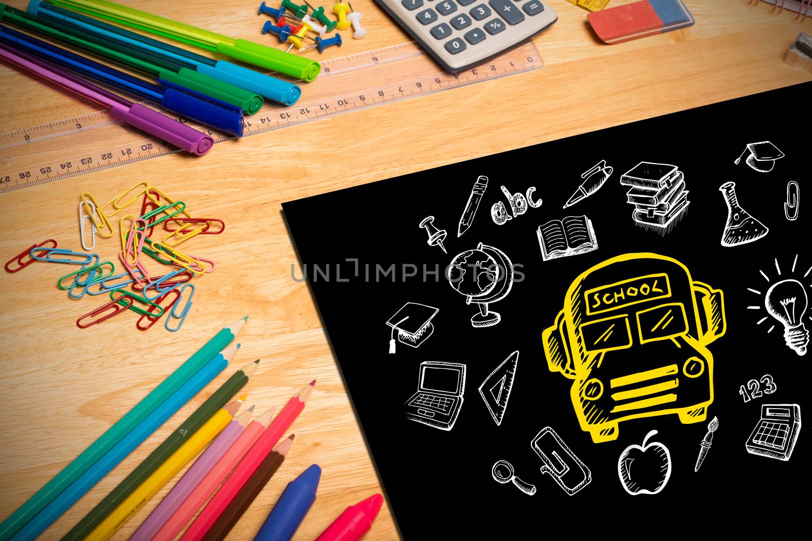 Composite image of education doodles against students desk