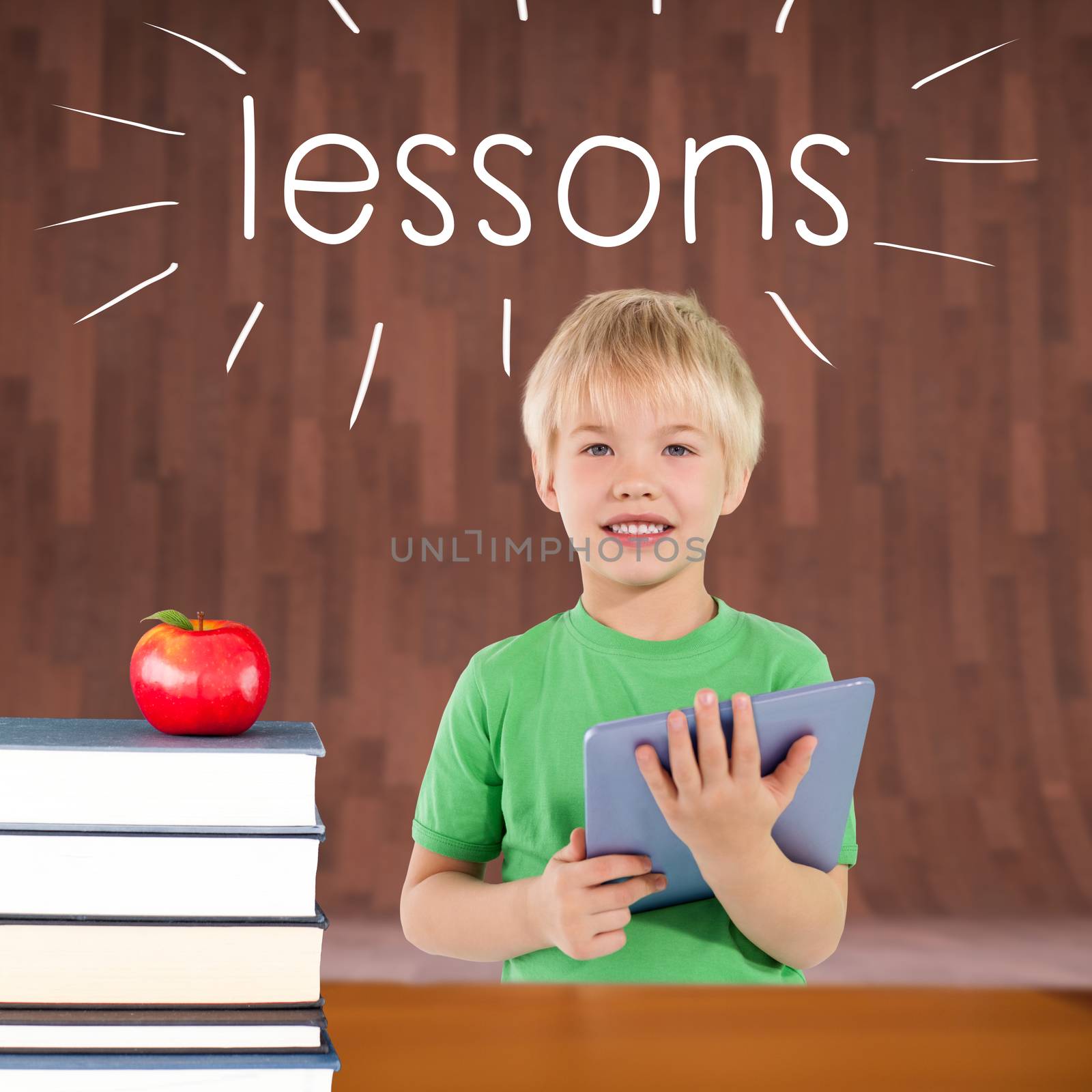 The word lessons and cute boy using tablet against red apple on pile of books