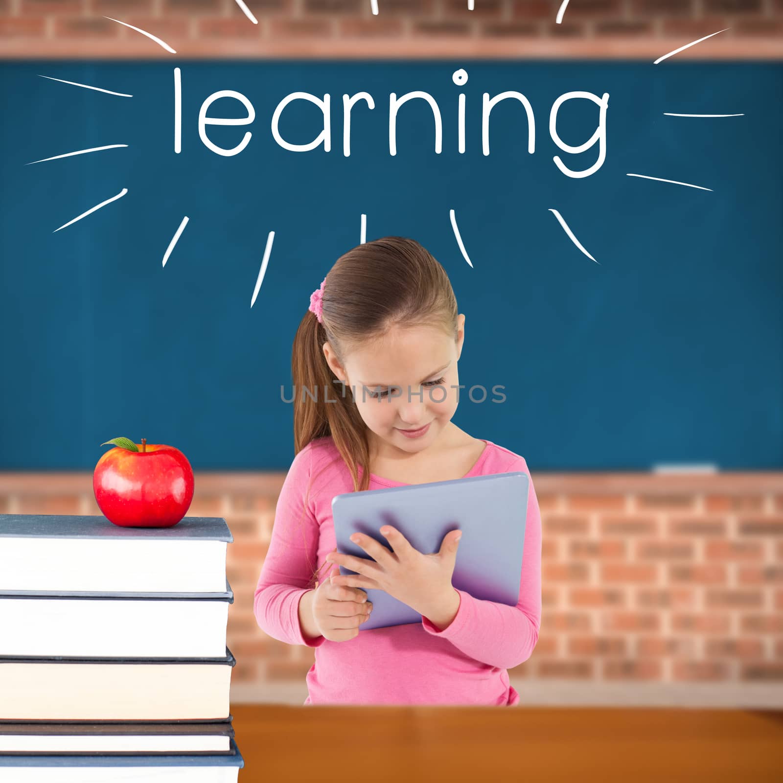 The word learning and cute girl using tablet against red apple on pile of books in classroom
