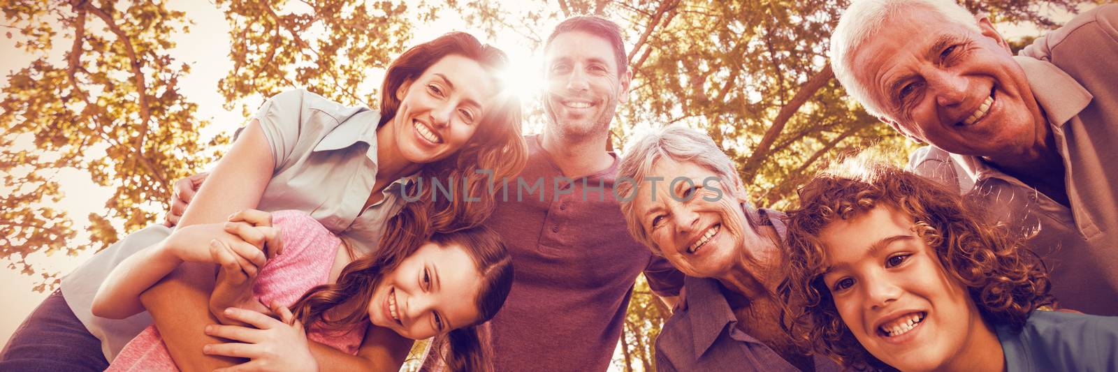 Happy family smiling in park on a sunny day