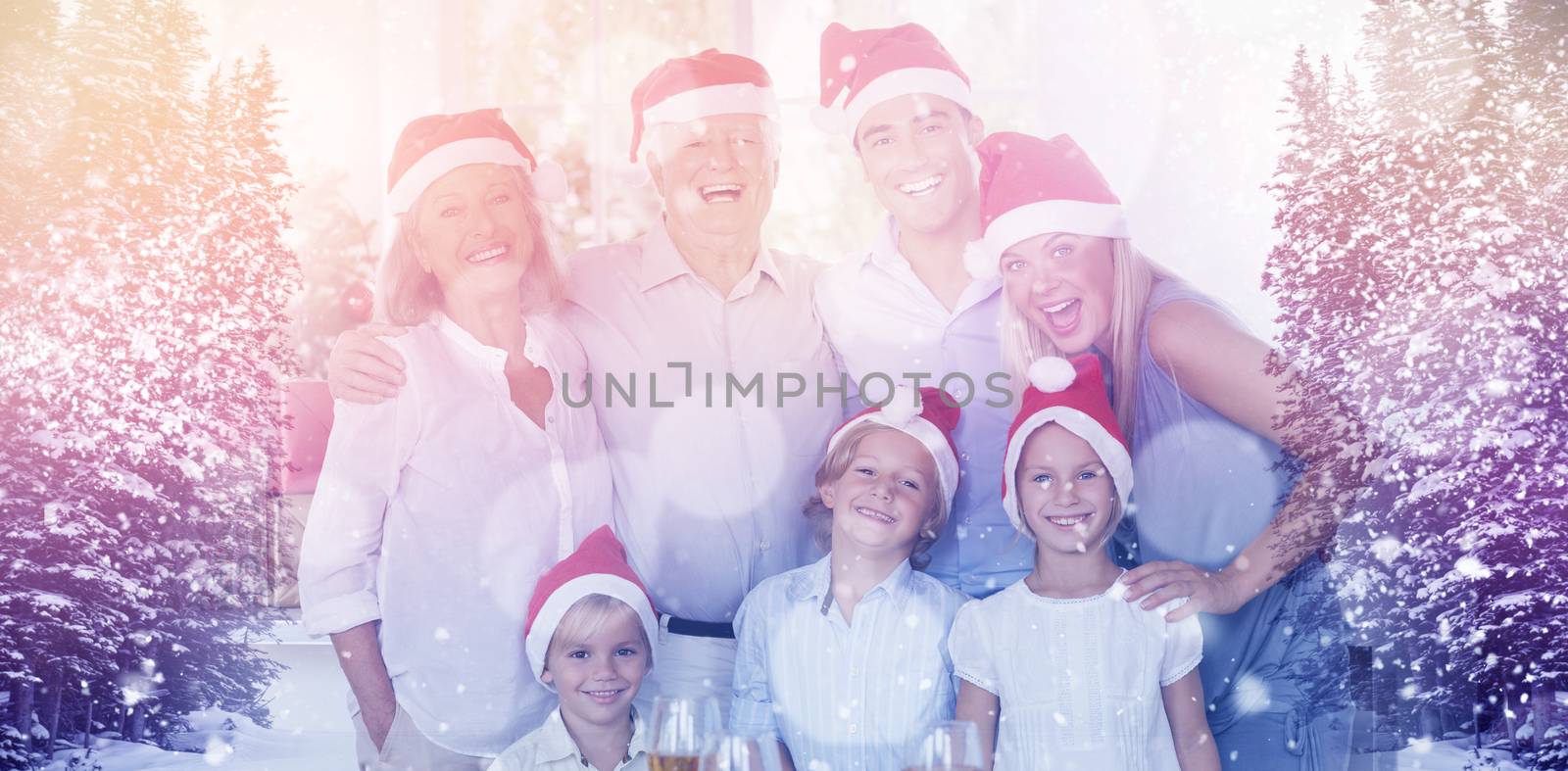 Family posing for photo against view of trees during snowfall