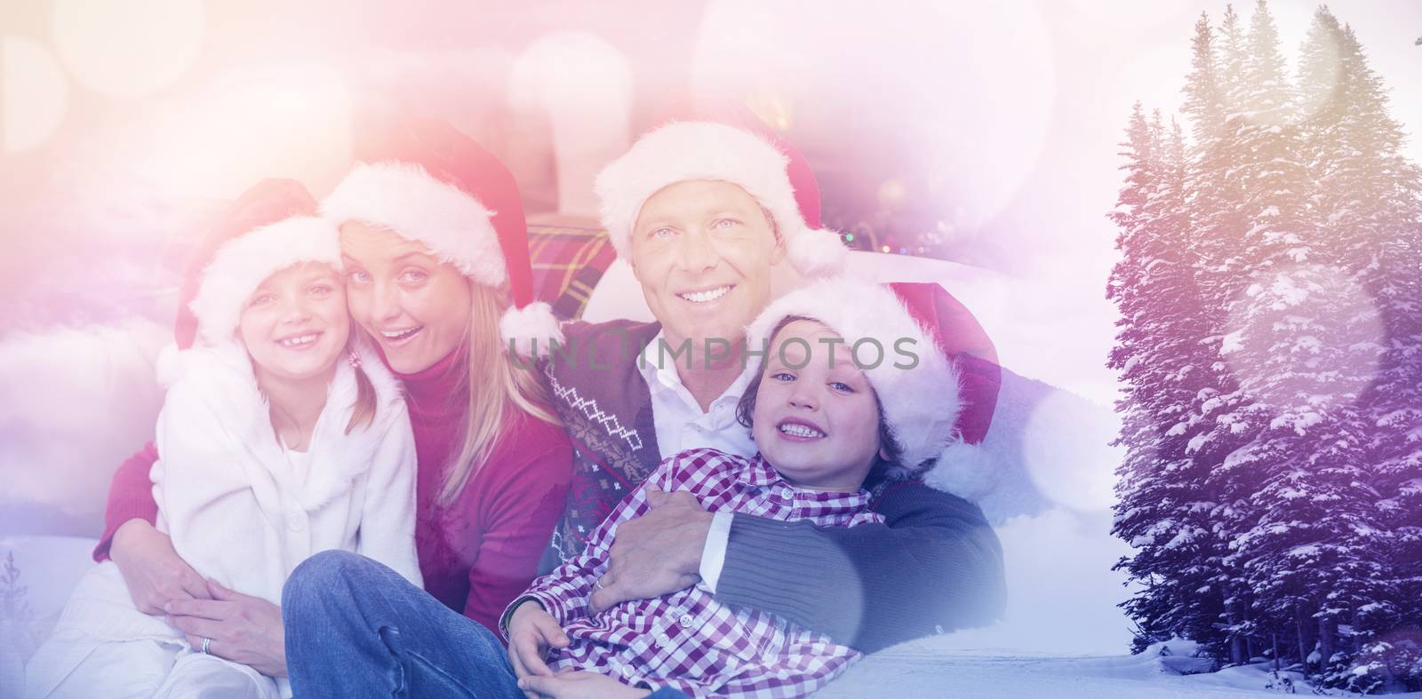 Scenic view of snow covered trees and mountain against festive family in santa hat hugging on couch