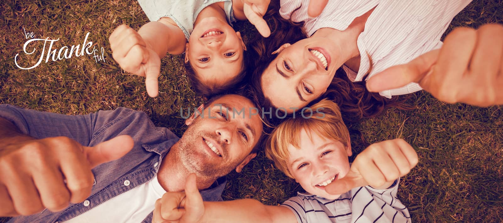 Digital image of happy thanksgiving day text greeting against happy family in park together gesturing thumbs up