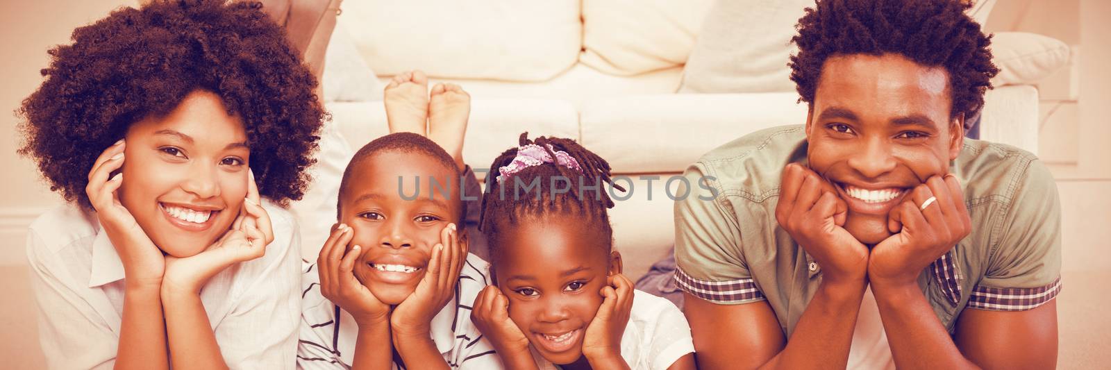 Portrait of happy family lying on floor at home
