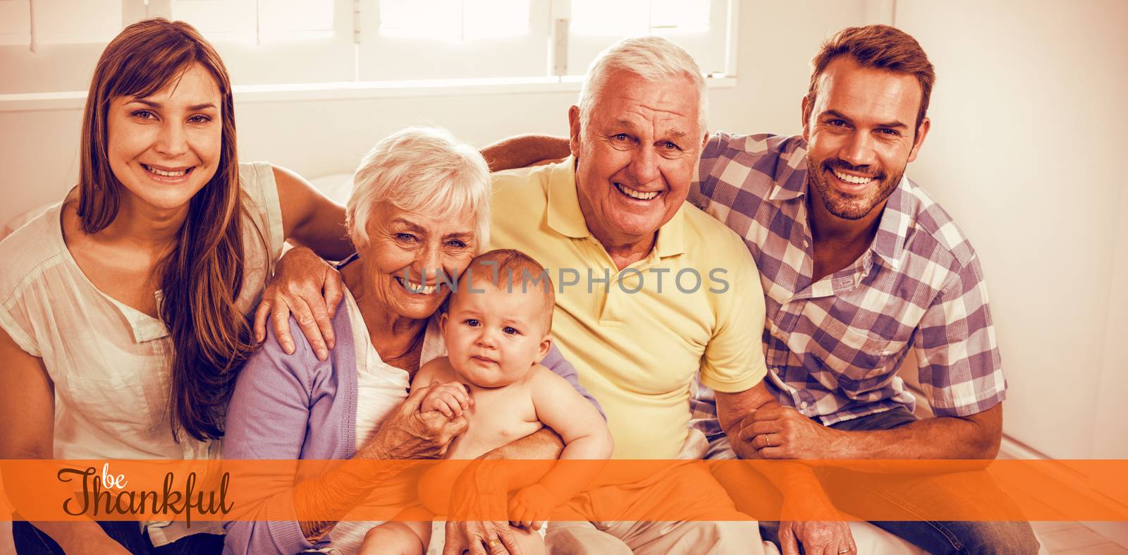 Thanksgiving greeting text against happy multi-generation family on bed at home