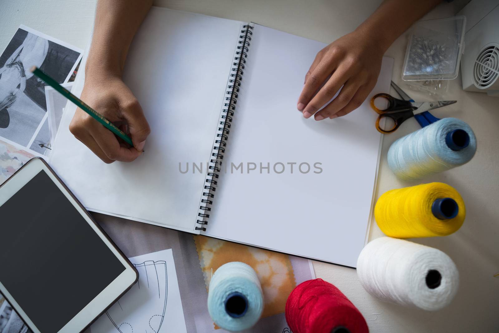 Overhead of fashion designer working at desk