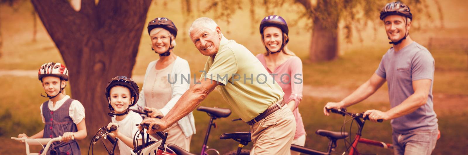 Portrait of happy family on bike at park