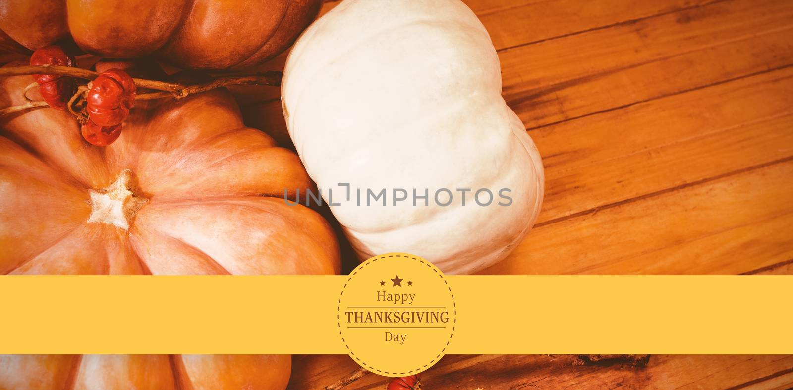 Happy thanksgiving against pumpkins with plant stems on table during halloween