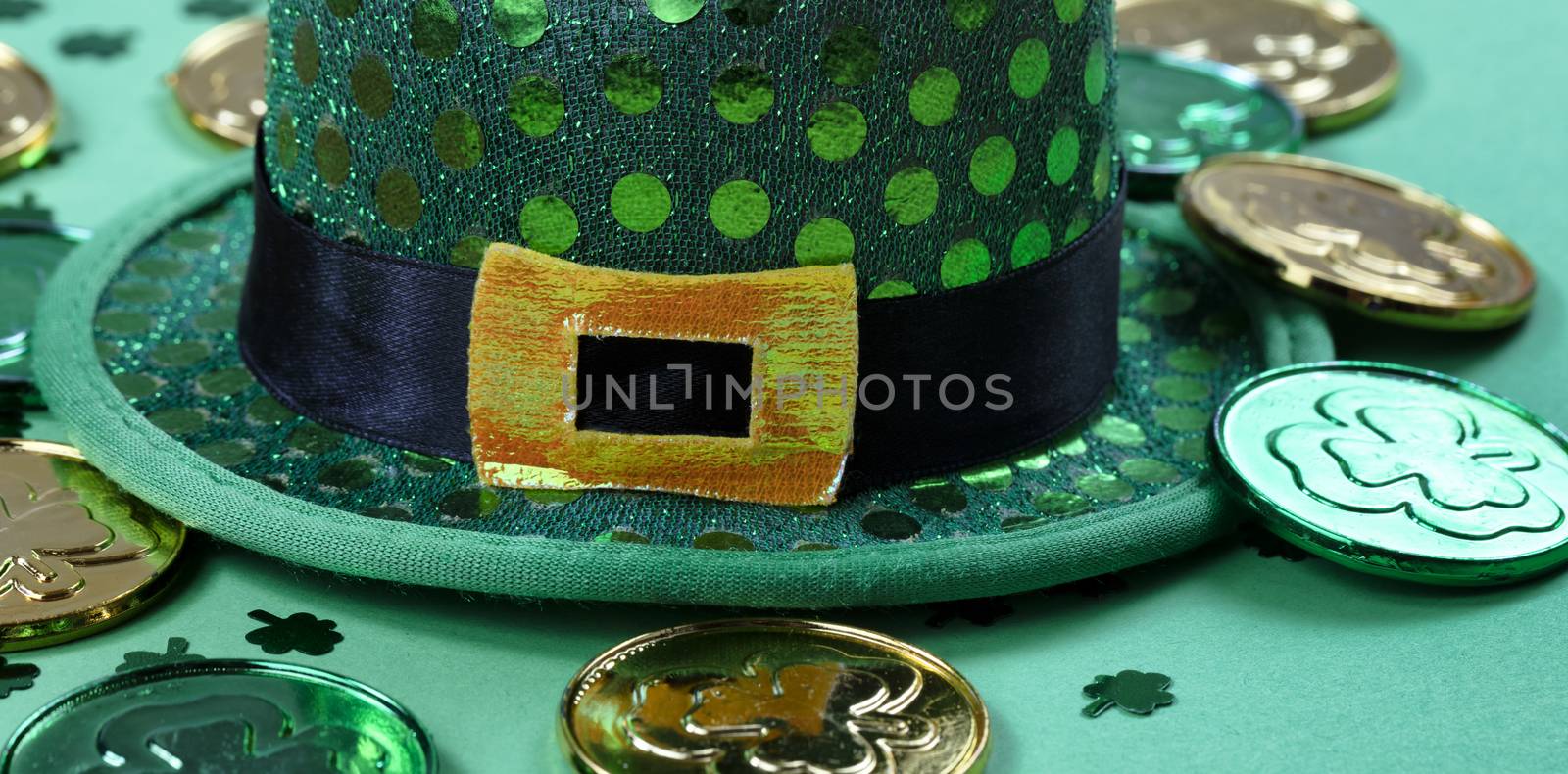 St Patricks Day with close up of hat and gold coins on green bac by tab1962