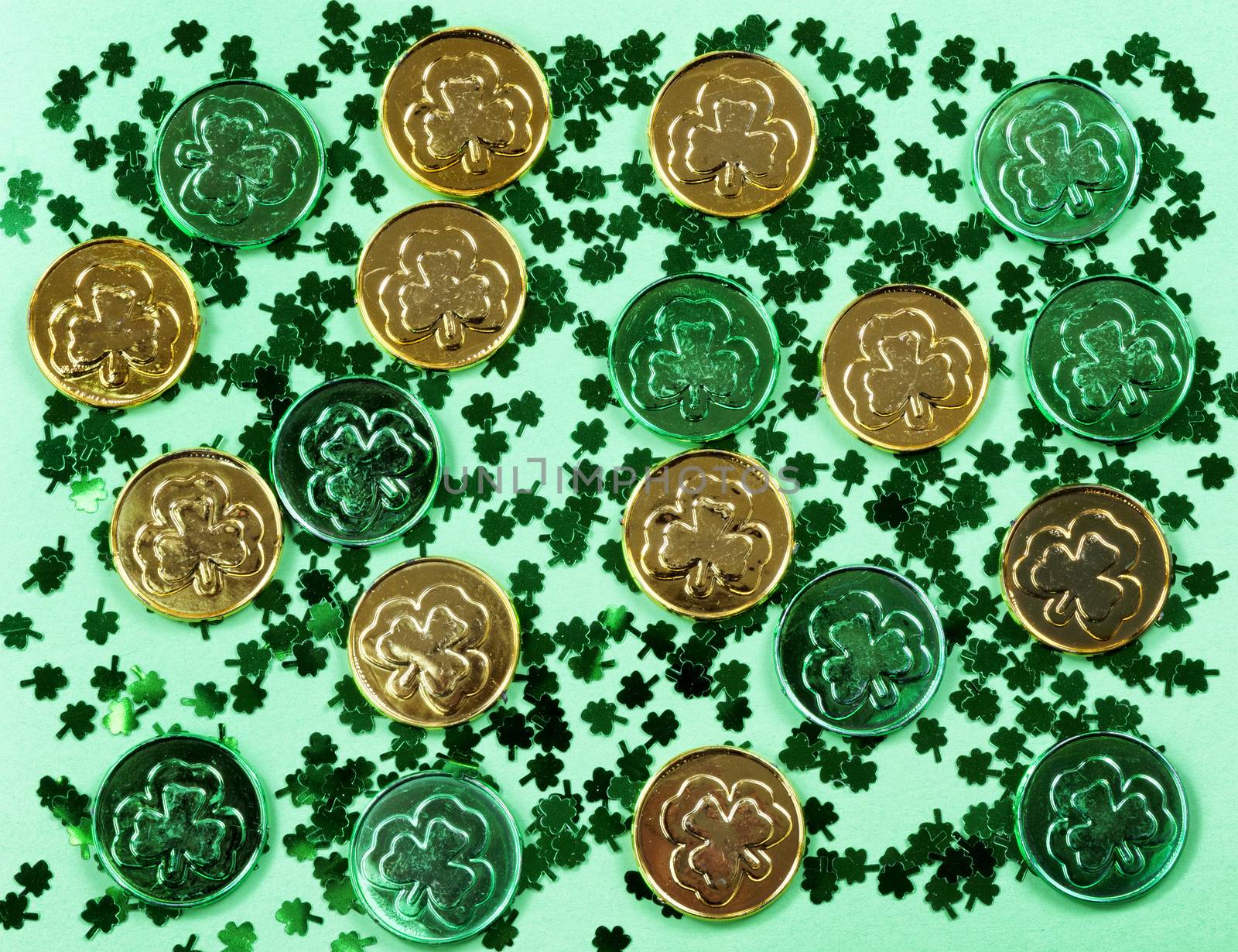 St Patricks Day with shamrocks and shiny coins on green backgrou by tab1962