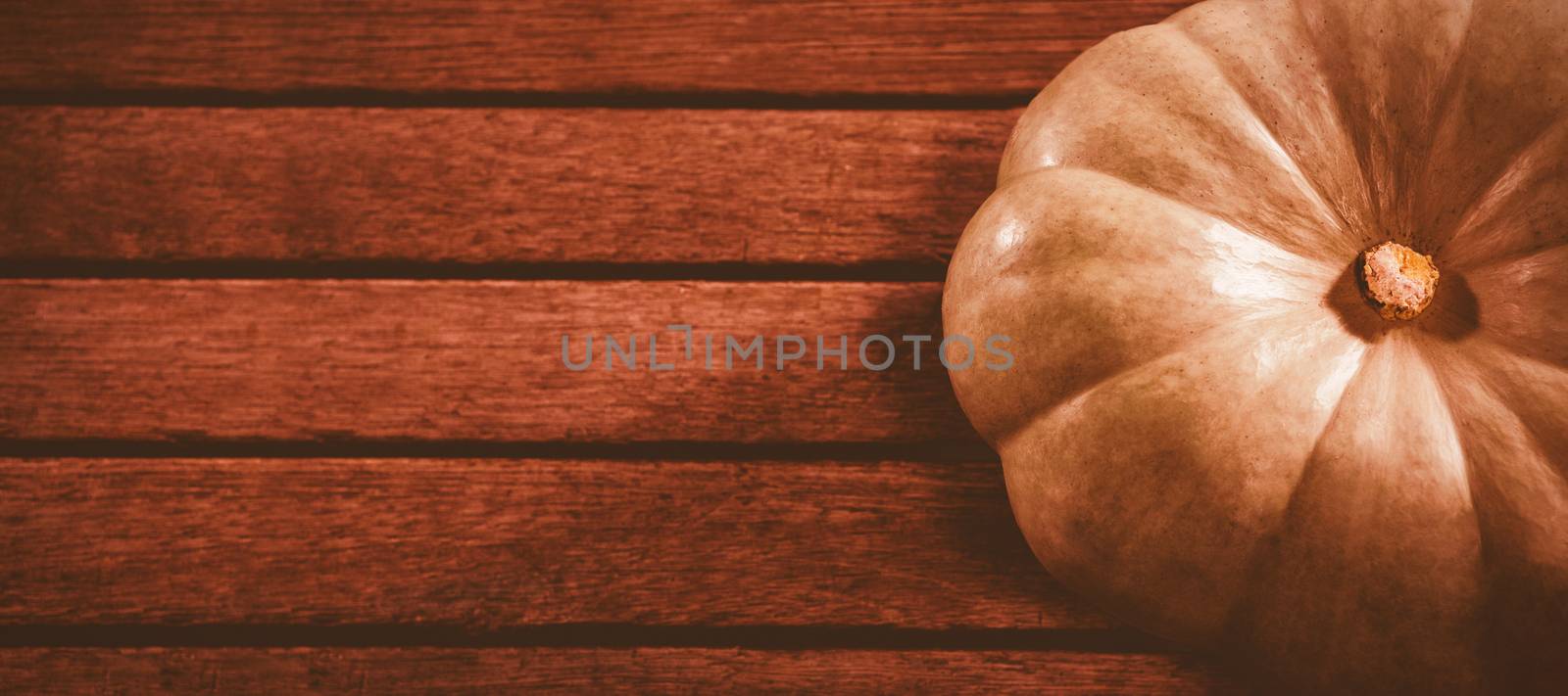 High angle view of white pumpkin on wooden table during Halloween