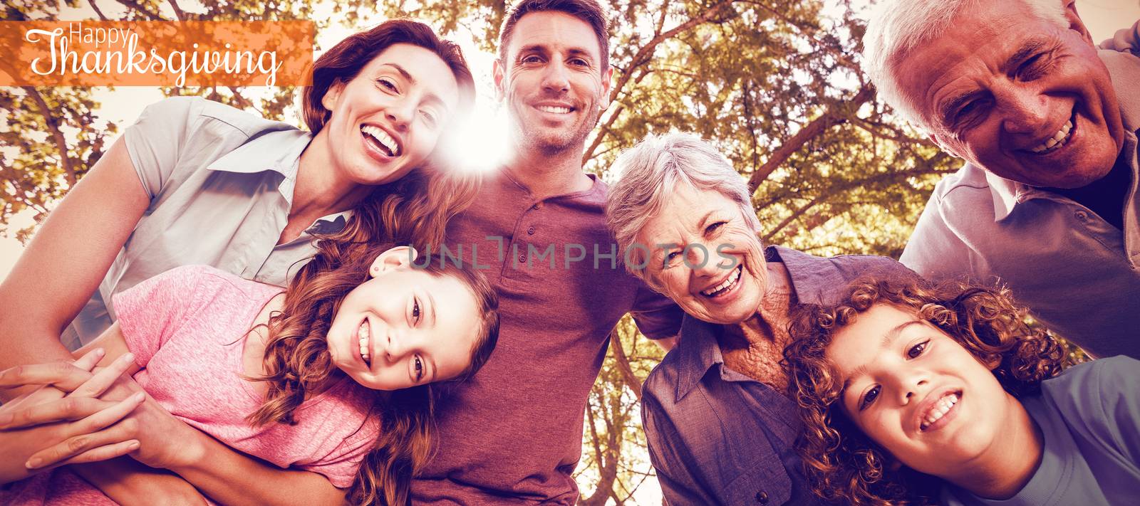 Thanksgiving greeting text against happy family smiling at park