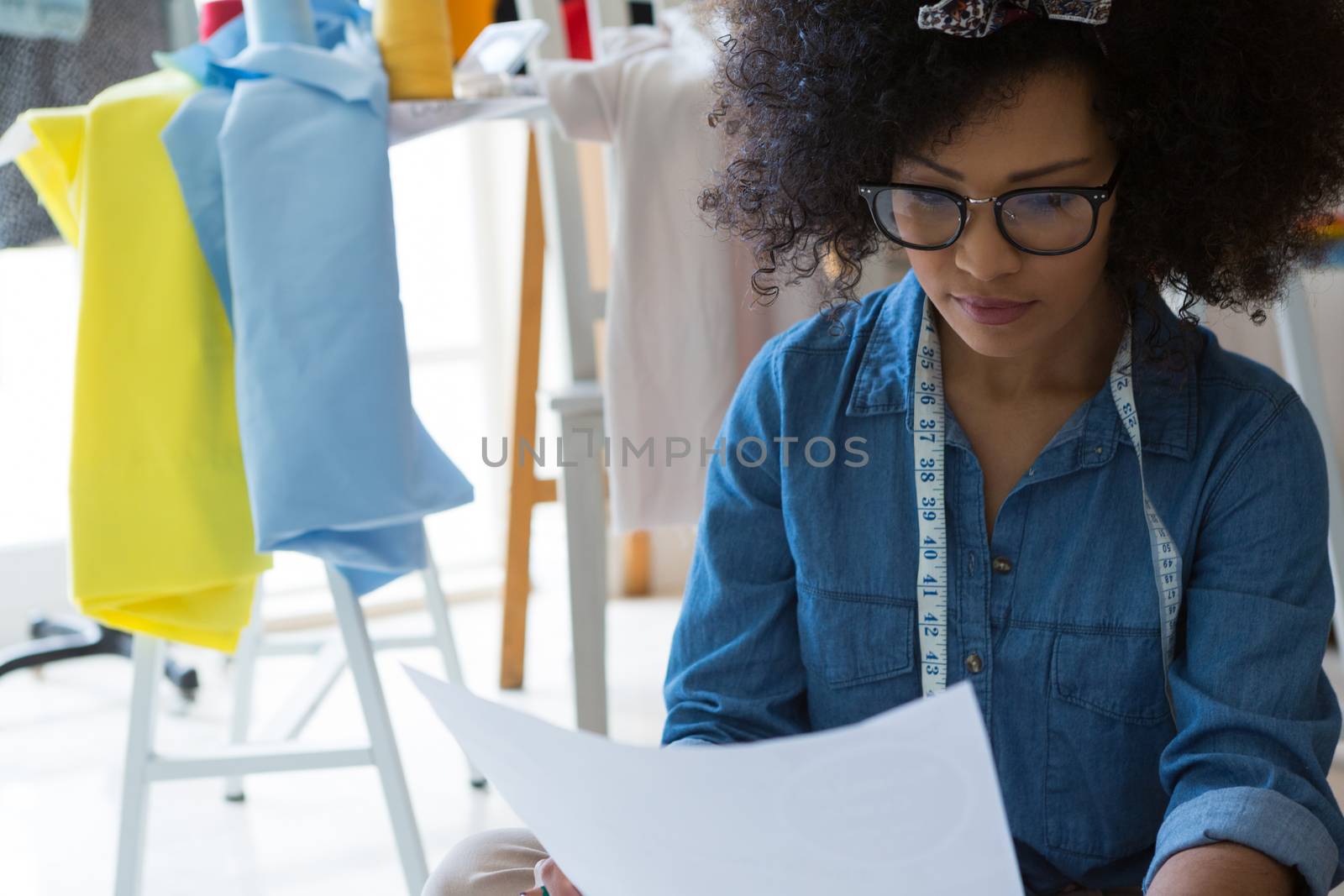 Female fashion designer looking at sketch at home