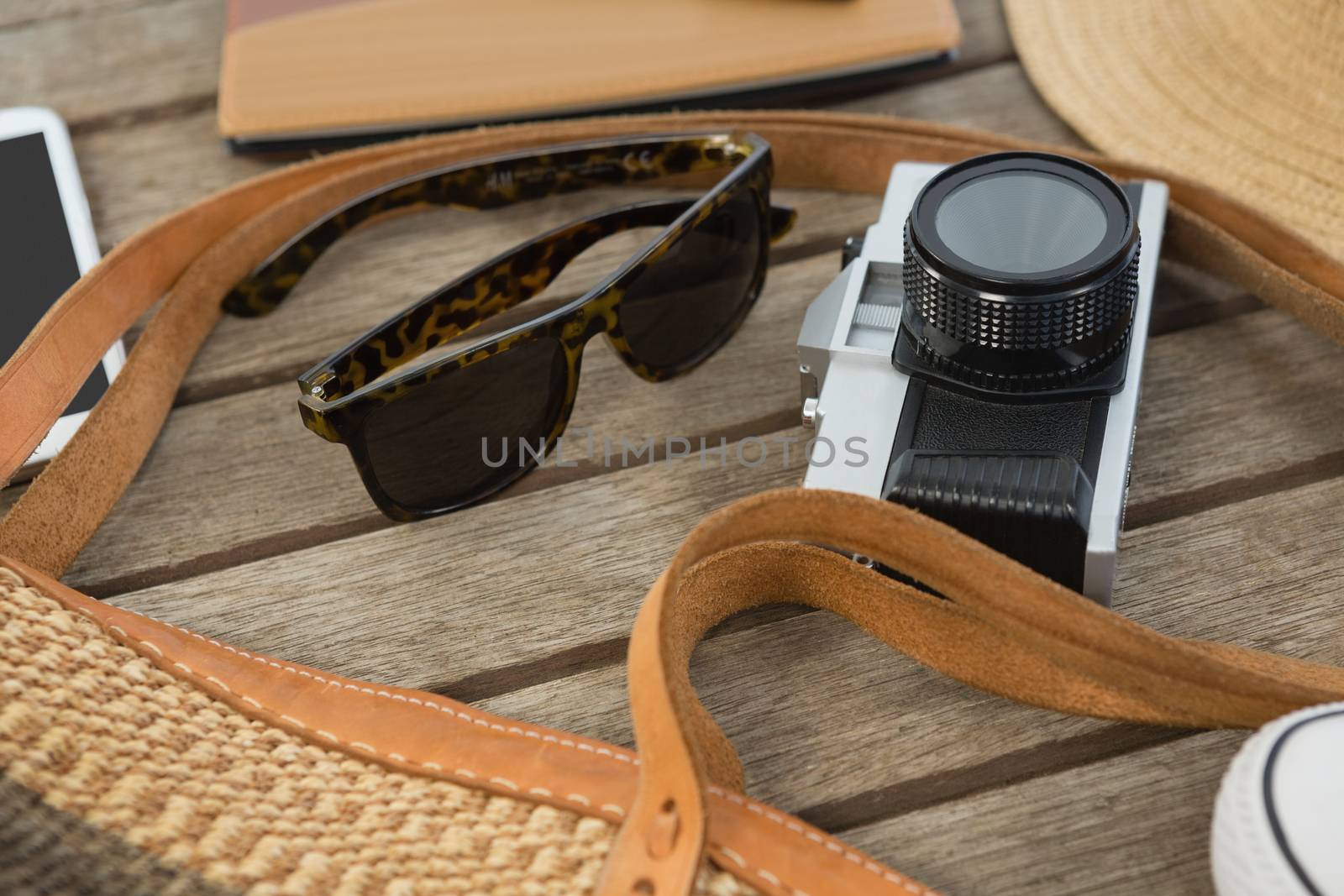 Close-up of travel accessories on wooden plank