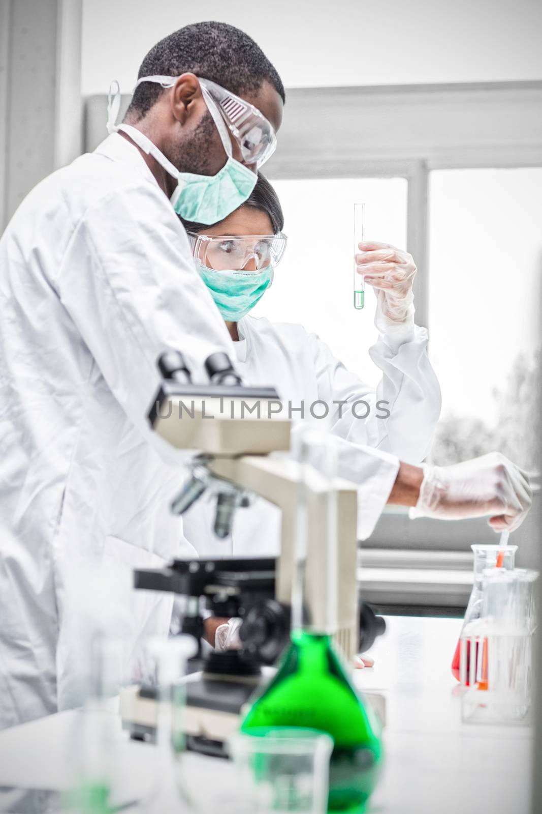 Chemists viewing liquids in the laboratory