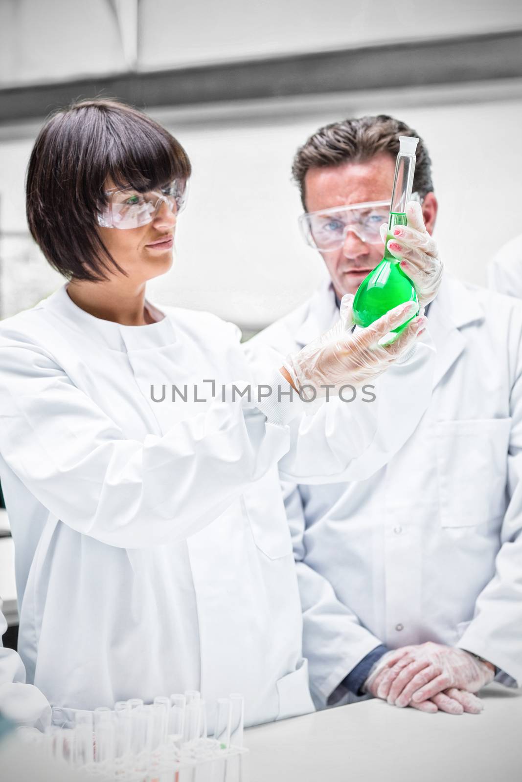 Scientist both looking green chemical 