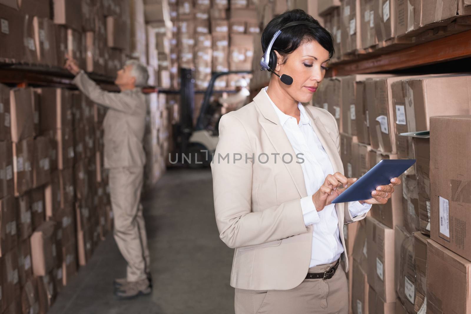 Pretty warehouse manager using tablet pc by Wavebreakmedia