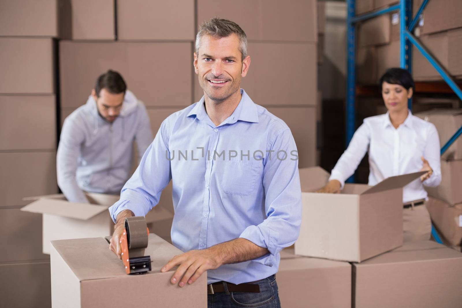 Warehouse workers packing up boxes by Wavebreakmedia
