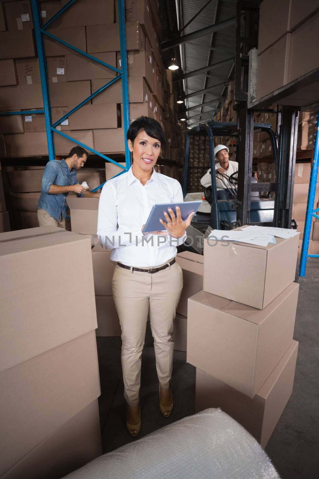 Warehouse workers preparing a shipment in a large warehouse