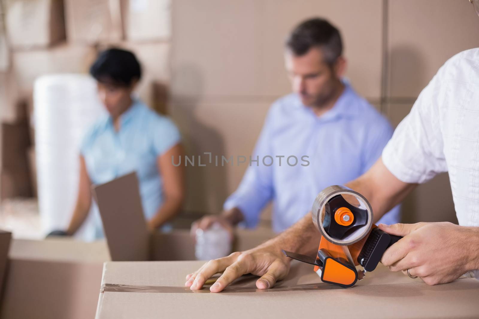 Warehouse workers preparing a shipment in a large warehouse