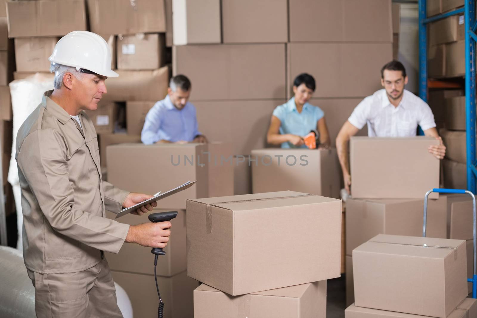 Warehouse workers preparing a shipment in a large warehouse