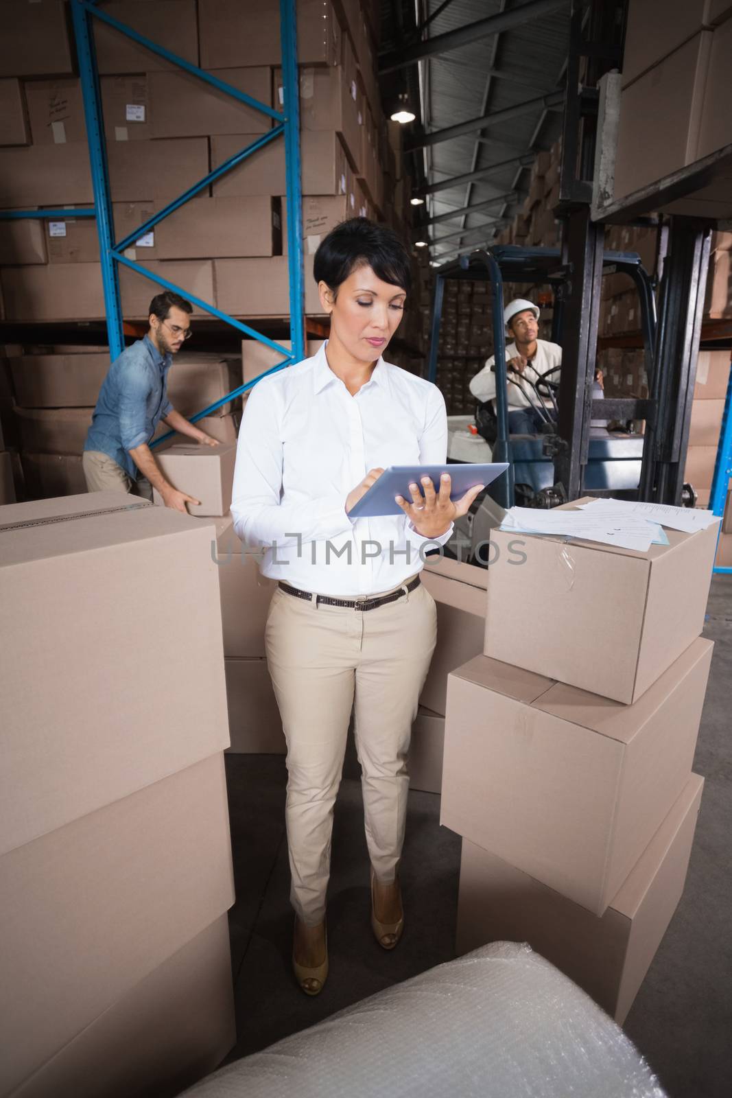 Warehouse manager using her tablet pc by Wavebreakmedia