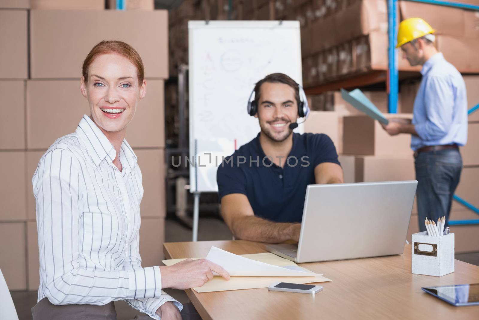 Warehouse team working together on shipment in a large warehouse