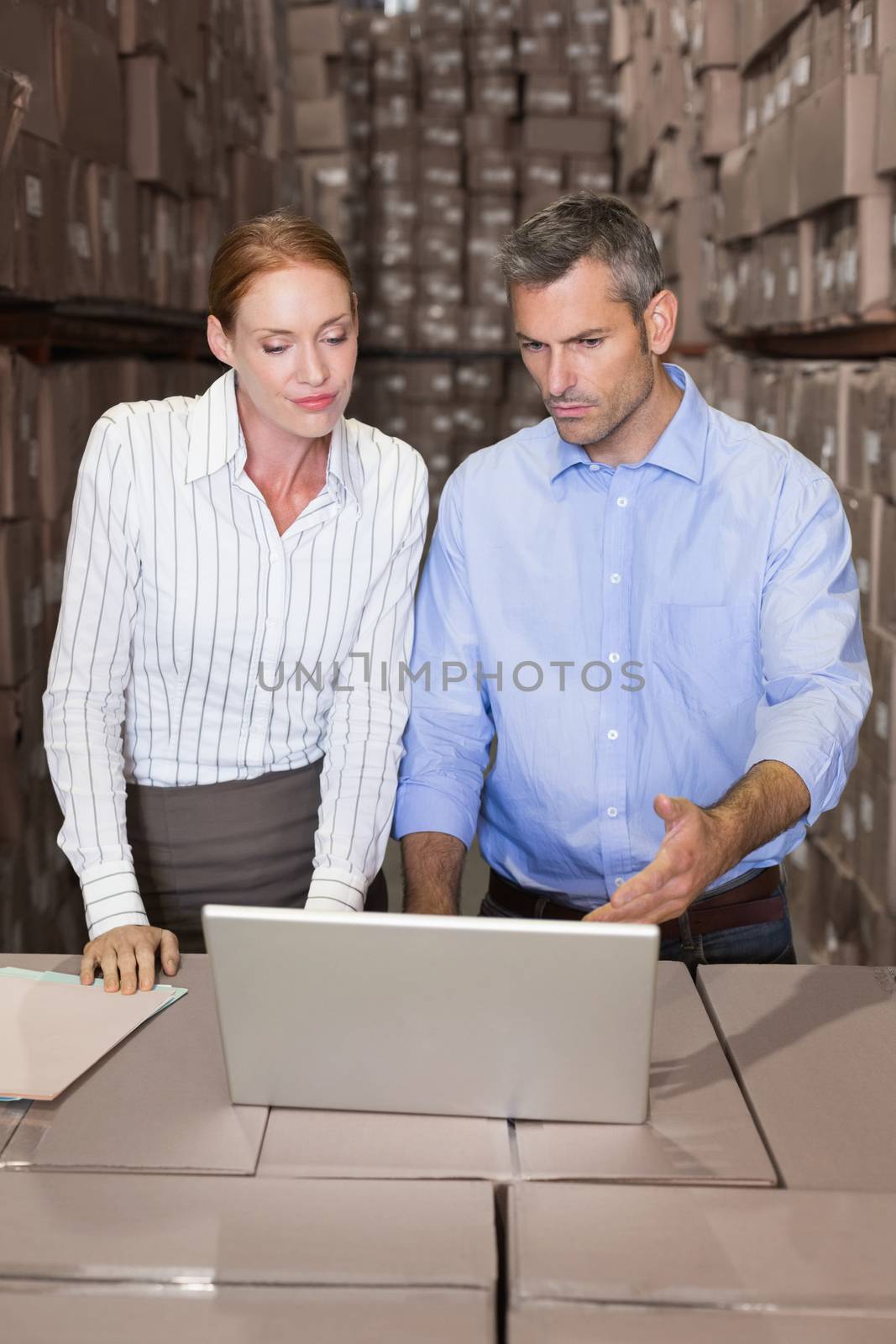 Warehouse team working together on laptop by Wavebreakmedia