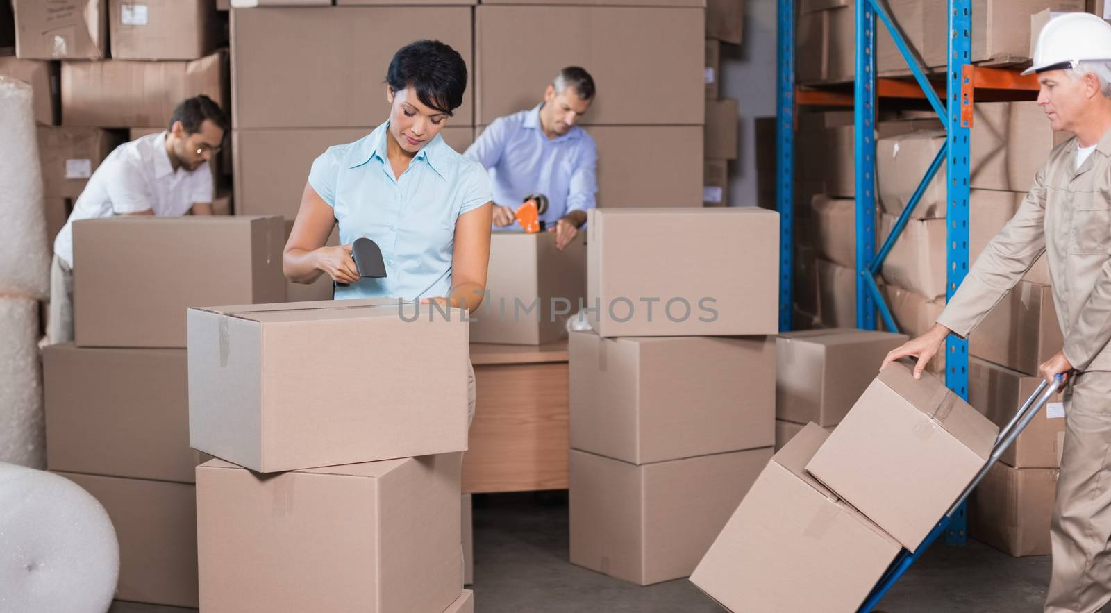 Warehouse workers preparing a shipment in a large warehouse